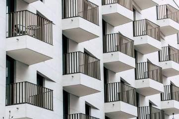 Balkonları sıralı beyaz apartman cephesi